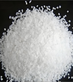 A small pile of white quartz sand sample, which is the raw material used by Xinghuo Glass Company to manufacture glass cups.