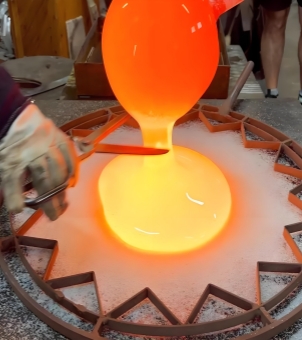 The manufacturing process of a glass ornament involves pouring molten glass into a star-shaped mold