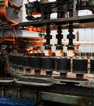 The image shows a part of the glass food storage bowl production line, demonstrating Xinghuo Glass's manufacturing capabilities.