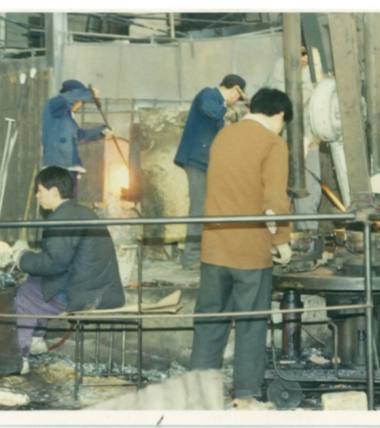 Xinghuo Glass was originally a handmade glass workshop; the picture shows several workers making glass cups