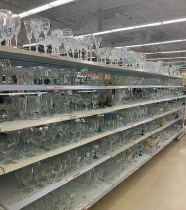 The shelves of a Xinghuo glass distributor display a variety of custom-made glassware created by Xinghuo for its clients