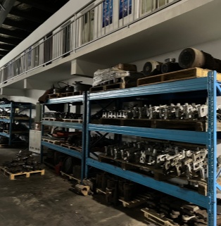 Xinghuo Glass Manufacturing Plant's Customized Molds and Components Warehouse Inside the Xinghuo Glass factory warehouse, heavy-duty blue shelves are neatly arranged with molds and custom parts for customer-customized products, showcasing the company's comprehensive mold management and flexible OEM/ODM customization capabilities.