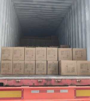 Xinghuo Glass's shipping container is filled with neatly arranged cartons of glassware, ready for export.
