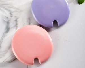 Close-up image of the pink and purple notched lid from Xinghuo Glass.