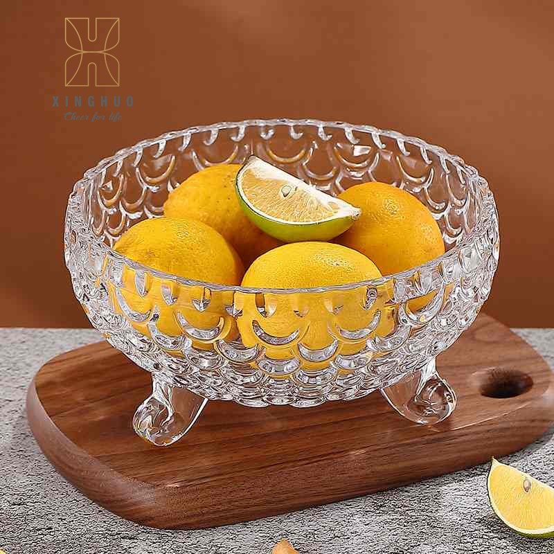 Image of a lidless, three-legged, embossed crystal glass fruit bowl for holding lemons.