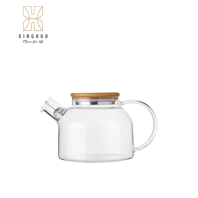 Image of a heat-resistant glass teapot with a bamboo lid and spring-loaded filter.