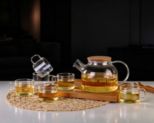 A set of six teacups placed on a bamboo tray. (Image of a heat-resistant glass teapot and its six-piece teacup set)